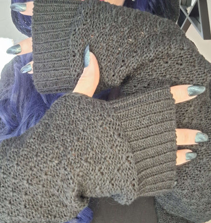 The Necessary Evil Athena Long Hooded Gothic Cardigan displayed elegantly on a hanger, emphasizing its plus-size fit and modern gothic design.