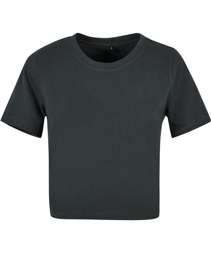 Model wearing a chic organic cotton stretch cropped t-shirt paired with high-waisted jeans, illustrating versatility and effortless style for refined summer looks.