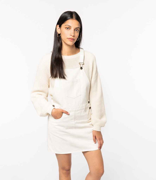 Luxurious organic cotton dungarees dress for women featuring unique recycled metal accents, perfect for eco-conscious fashion enthusiasts.