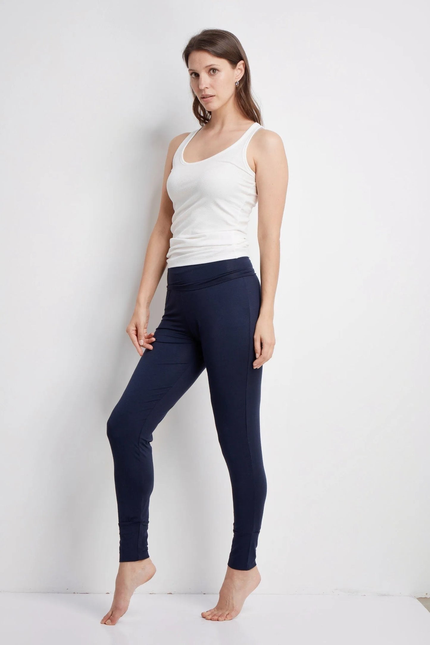 Elegant women's micro modal yoga trousers paired with a simple tee, demonstrating a chic outfit for casual errands, made from sustainably sourced fabric.