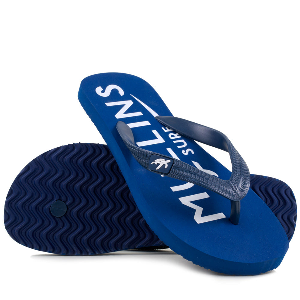 Close-up of Mullins Bay luxury flip flops in vibrant blue, showcasing the bouncy rubber sole and textured safety features.