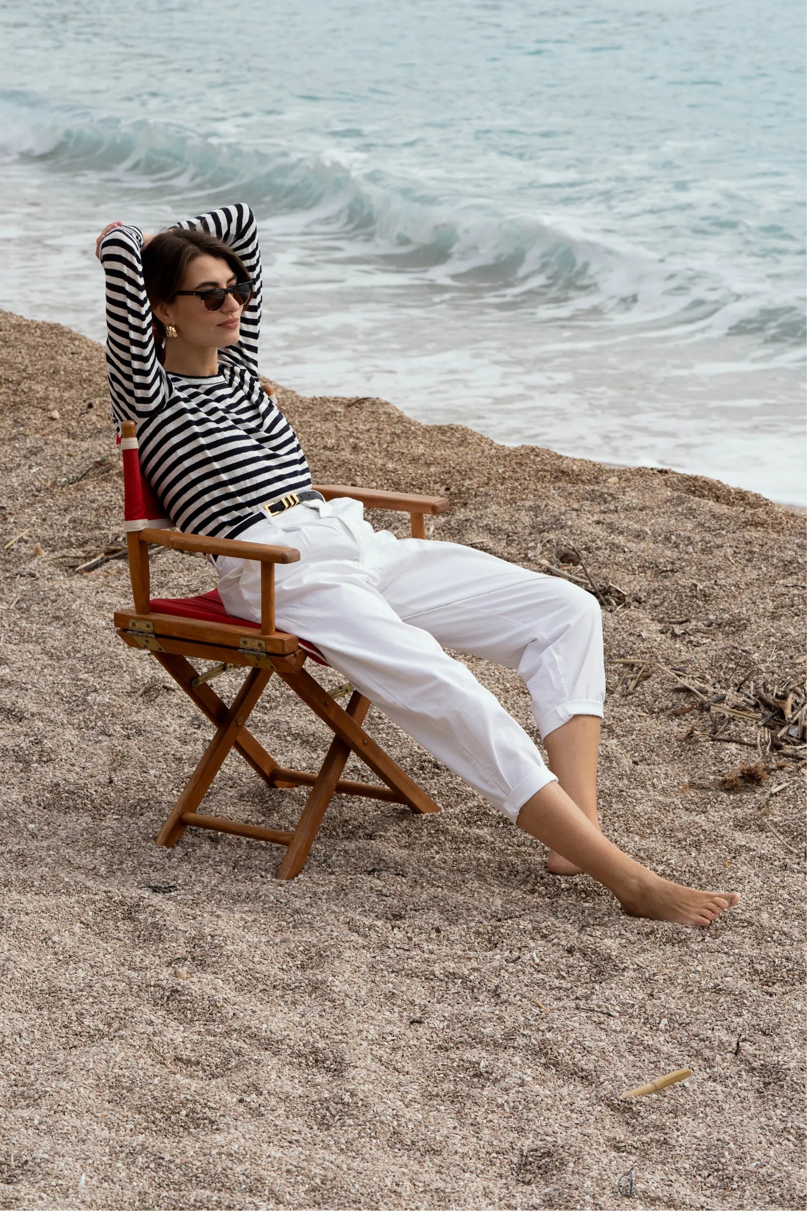 Stylish women's long sleeve striped linen t-shirt displayed elegantly with jeans and accessories, representing effortless summer fashion.