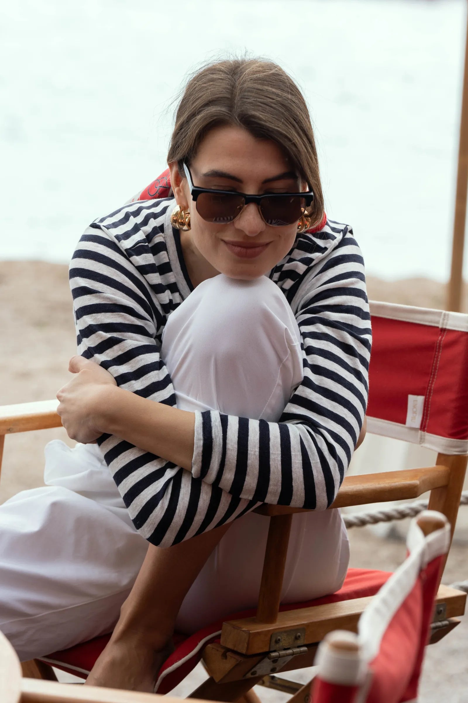 Close-up of luxurious 100% linen fabric on a women's striped t-shirt, highlighting its softness and moisture-wicking properties for comfort.