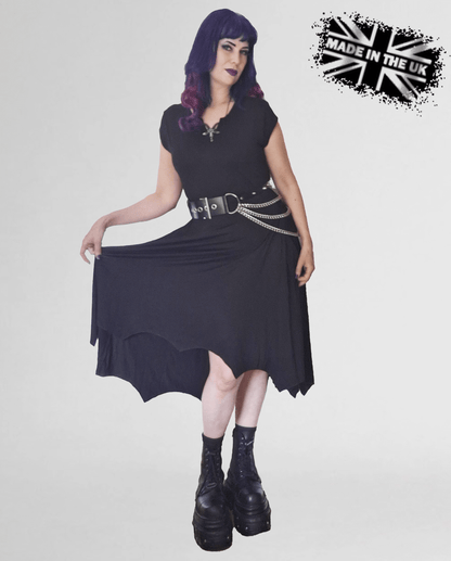 Gothic-inspired Necessary Evil Evaki Hi-Low Dress on model, exuding an effortless blend of elegance and edge against a dramatic backdrop.