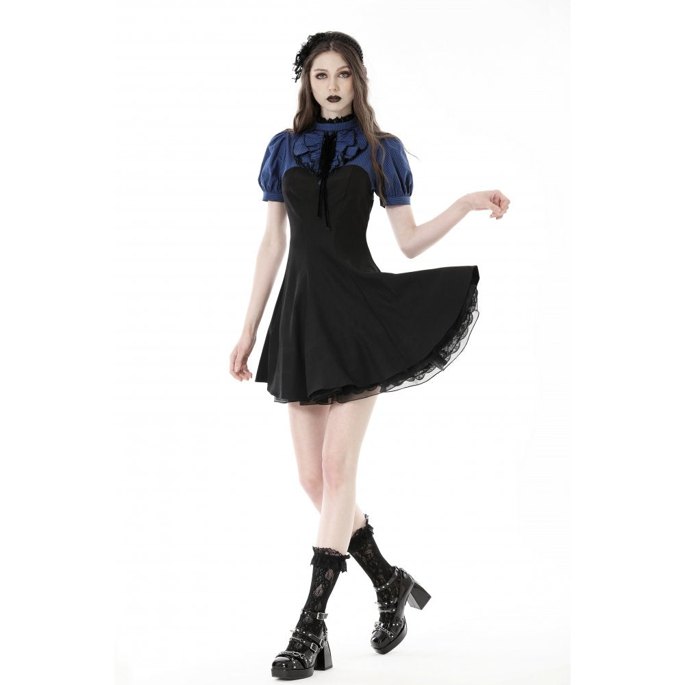 Model wearing the Deep Blue Nilima Dress by Dark In Love, perfect for chic occasions with its short puffy sleeves and bold stripe design.