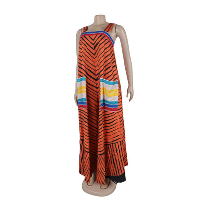 Luxurious CM.YAYA Women’s Striped Wide Leg Sleeveless Jumpsuit with Pockets, showcasing an elegant striped pattern against a summer backdrop.