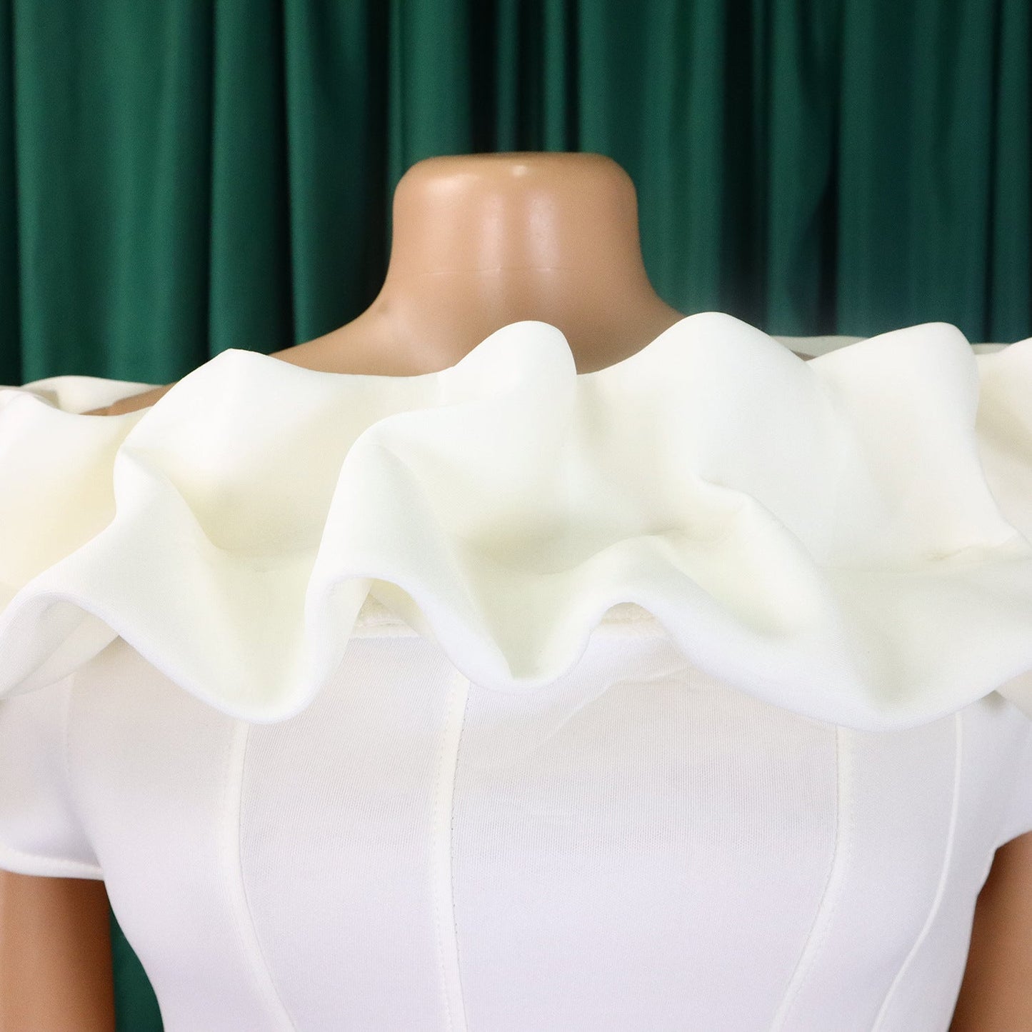 Close-up detail of the off-shoulder neckline and exquisite embroidery on a premium mermaid evening gown, highlighting its exquisite craftsmanship and sophisticated style.