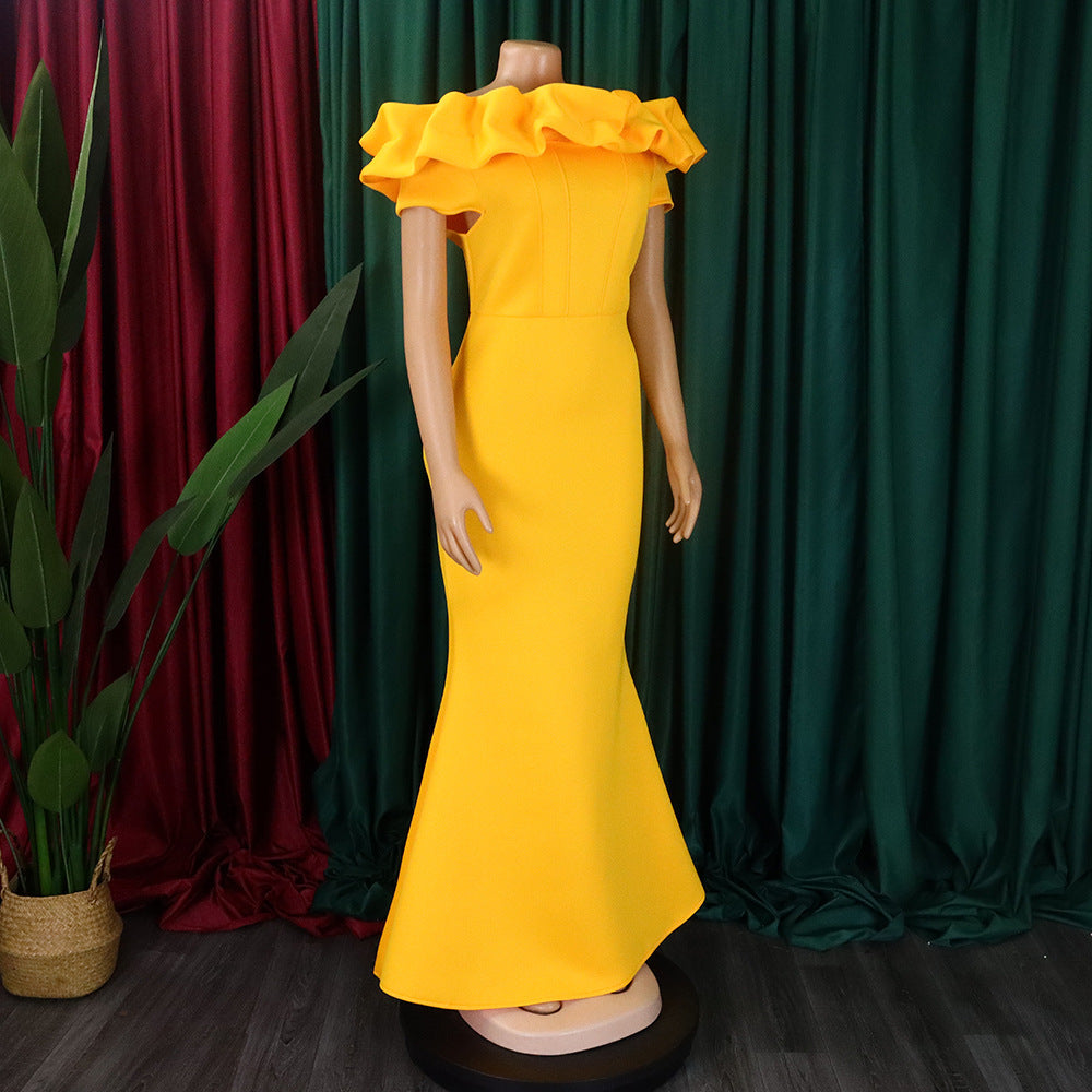 Model wearing the sophisticated off shoulder mermaid evening dress styled with a chic updo and statement jewellery, exuding luxury for a glamorous night out.