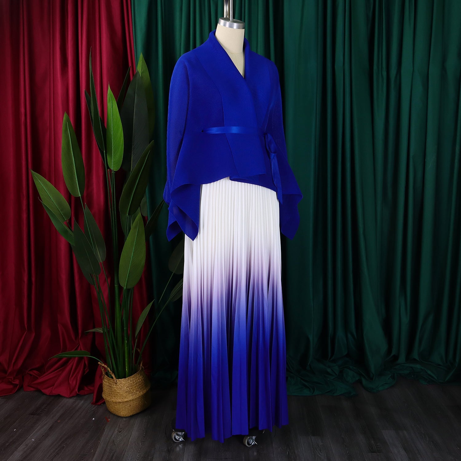Chic two-piece ensemble by CM.YAYA, including a flowing gradient blouse with batwing sleeves and a floor-length pleated skirt.