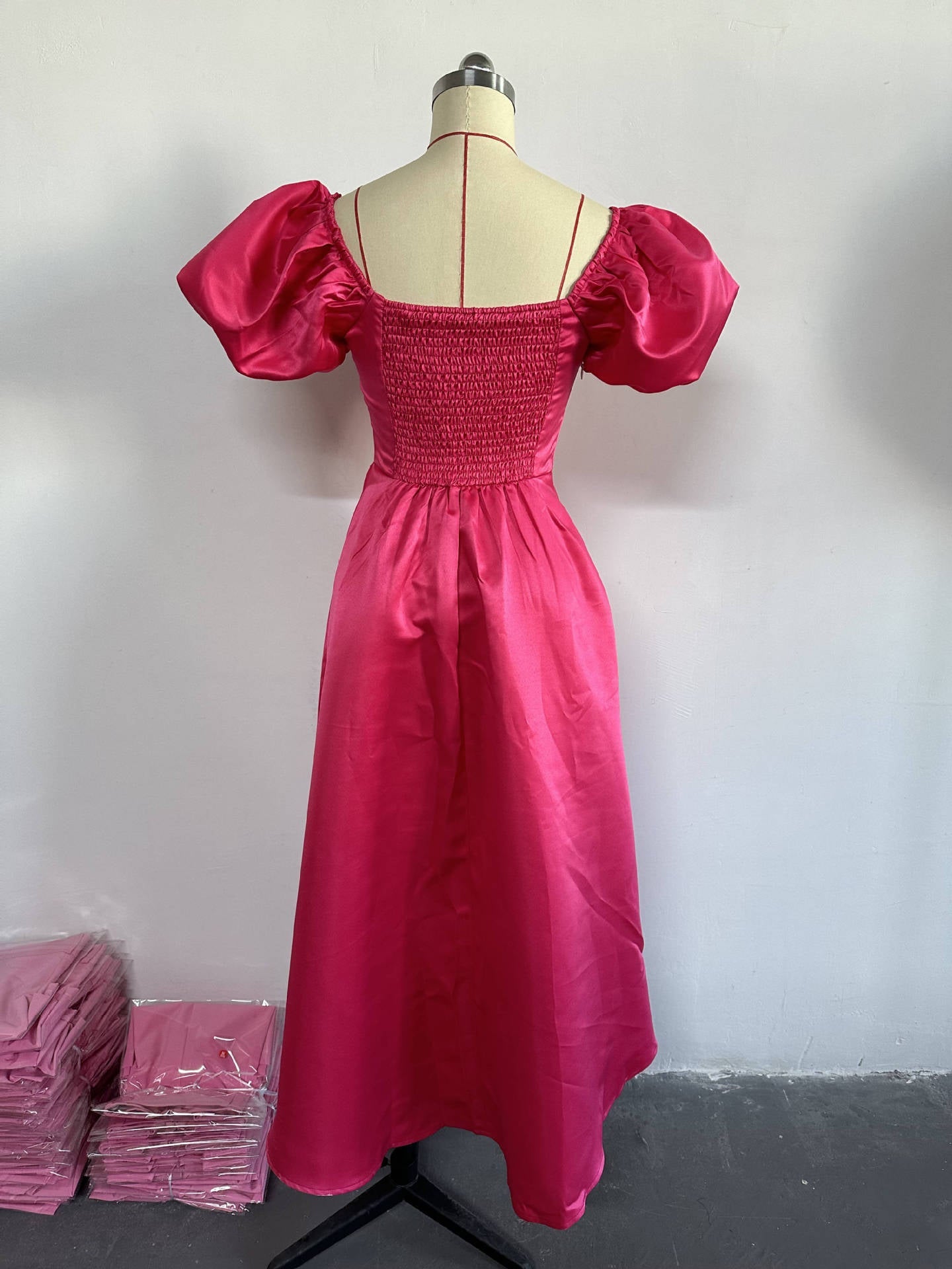 Close-up of the intricate Puff Sleeves and Sweetheart Neckline on a luxurious Women's A-Line Midi Dress in Deep Pink, showcasing a unique backless design.