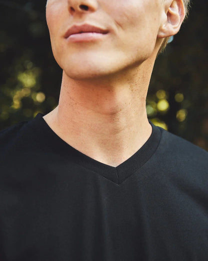 Versatile Fairtrade organic cotton men's V-neck t-shirt, draping softly for an elevated look, essential for the mindful luxury wardrobe.
