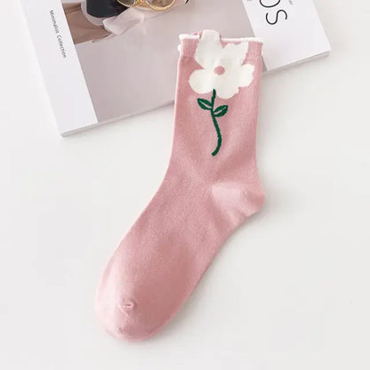 Luxurious Women's Tie-Dye Middle Tube Socks adorned with a charming white flower motif on a soft pink background, perfect for effortless elegance.