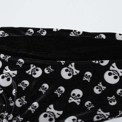Fashionable display of Punk Rave flared trousers in black velvet with a unique skull design and waist tie, epitomising timeless gothic elegance.
