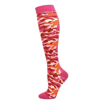 Luxurious Women's Knee Length Compression Travel Socks in vibrant pink, orange, and red camouflage design for comfort, style, and circulation.