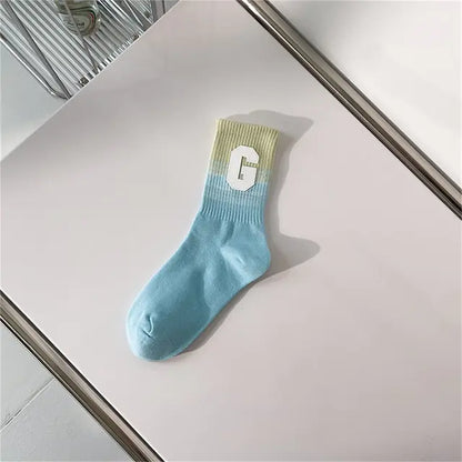 Luxurious Women's Tie-Dye Middle Tube Socks designed with soothing blue gradient shades and a prominent letter 'G', ideal for elevating everyday style.