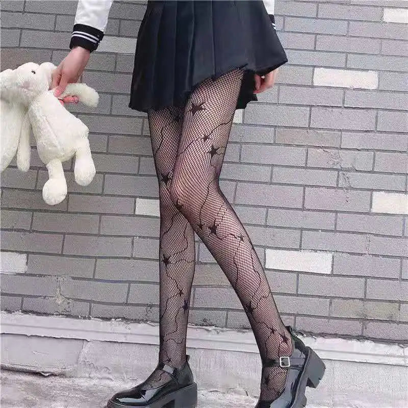 Dazzling Dreams Studio Pentacle Design Fishnet Stockings showcased on stylish black skirt, offering a chic black and white fashion essential look.