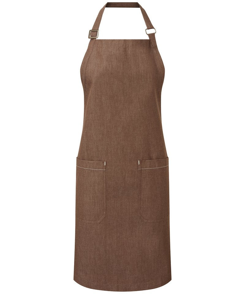 Luxury organic cotton denim bib apron showcasing adjustable antique brass buckle, eco-friendly features, and elegant design with deep mitred pockets.