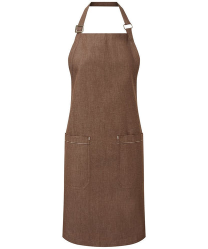Luxury organic cotton denim bib apron showcasing adjustable antique brass buckle, eco-friendly features, and elegant design with deep mitred pockets.