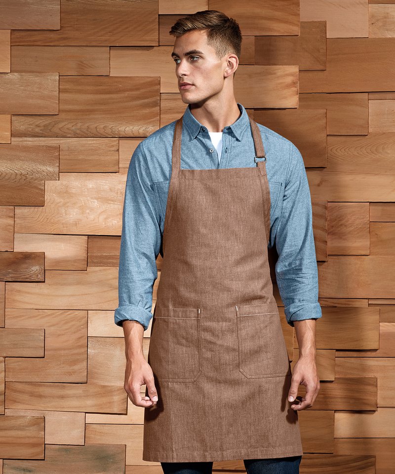 Luxury organic cotton denim bib apron featuring adjustable antique brass buckle, designed for eco-conscious culinary enthusiasts.