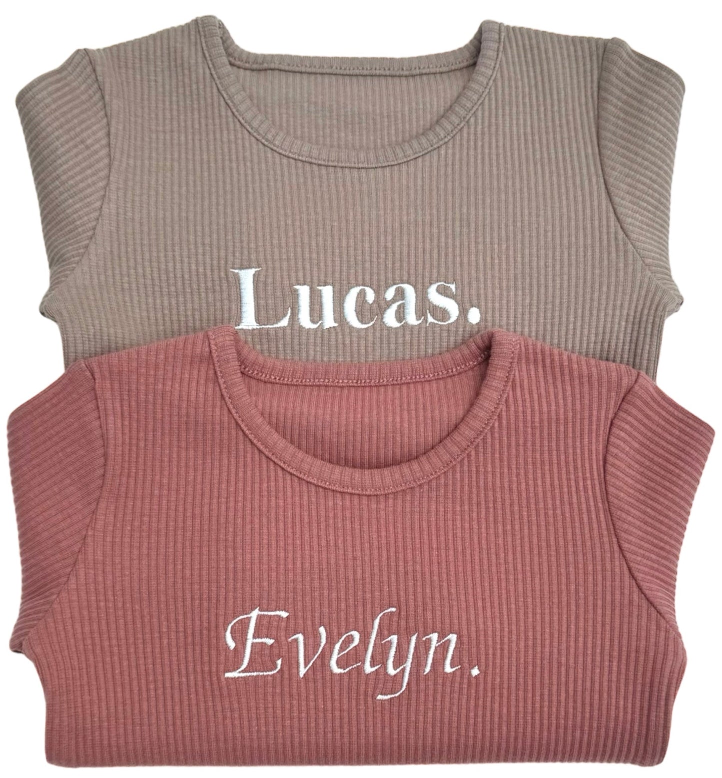 Family in matching DreamBuy luxury ribbed pyjamas set in leather pink, perfect for holiday play and sleep, embodying chic minimalist style for unforgettable family moments.