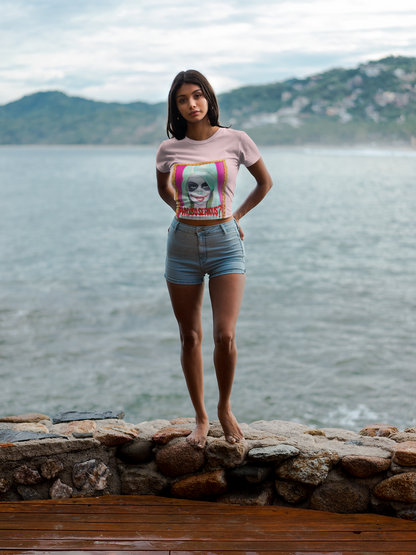 Trendy women’s graphic t-shirt in pink, featuring a striking design of a Joker figure with signature makeup, ideal for a luxurious casual look by the seaside.