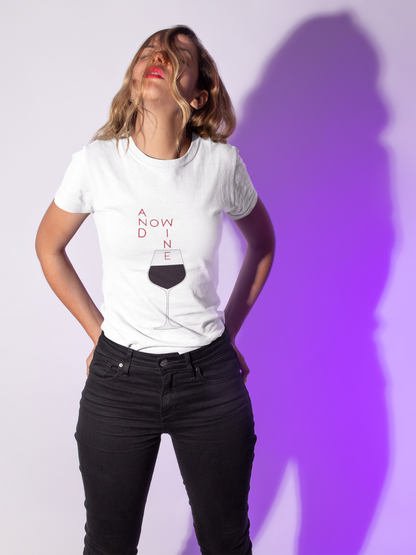 White women's t-shirt presenting the witty phrase 'And Now Wine', complemented by a chic wine glass illustration, ideal for casual wine gatherings.