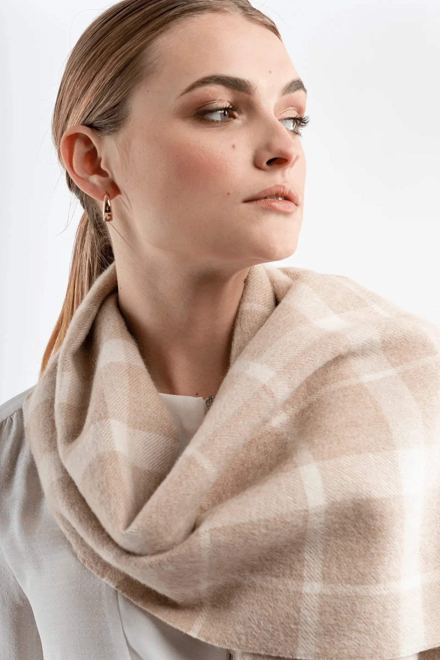 Timeless undyed alpaca plaid scarf draped elegantly, demonstrating its versatility and refined style for any outfit.