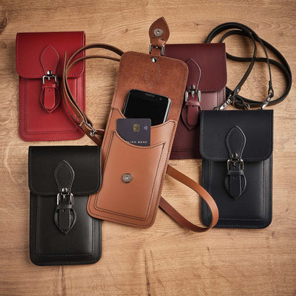 Stylish model displaying the Luxury Navy Blue Leather Mobile Phone Pouch, emphasizing versatility in wear with an adjustable crossbody strap for a sophisticated look.
