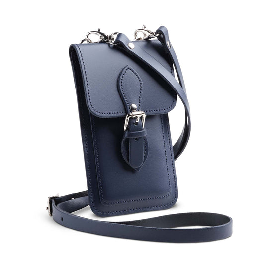 Luxury handmade navy blue leather mobile phone pouch by Zatchels, featuring a stylish magnetic fastener and adjustable crossbody strap, ideal for carrying smartphones elegantly.