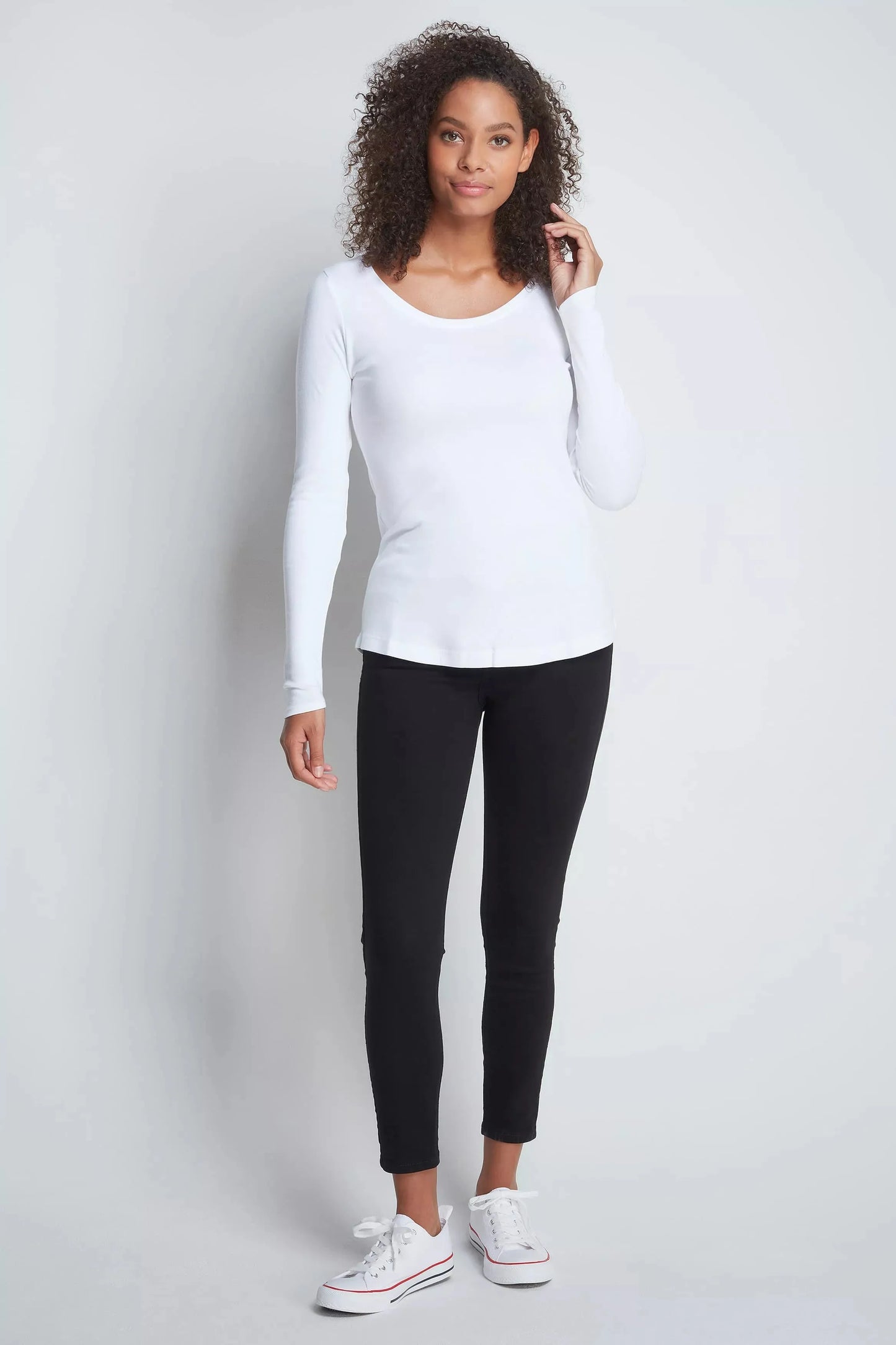 Versatile Women's Long Sleeve Scoop Neck T-Shirt displayed on a hanger, illustrating its elegant shape and breathable quality ideal for all-day wear.