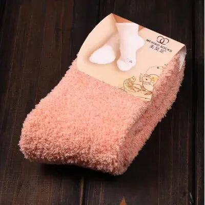 Cozy Women's Bed Socks in soft pink shade, designed with luxurious coral fleece for a comforting winter experience, perfect for holiday gifting.