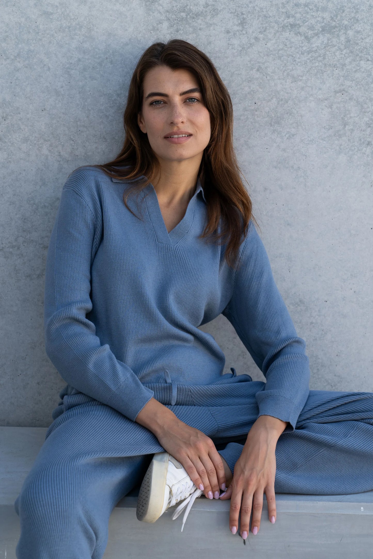 Elegant close-up of ribbed fabric on luxury wide-leg trousers, crafted from a soft blend of 85% Pima cotton and 15% baby alpaca, perfect for sophisticated lounging.
