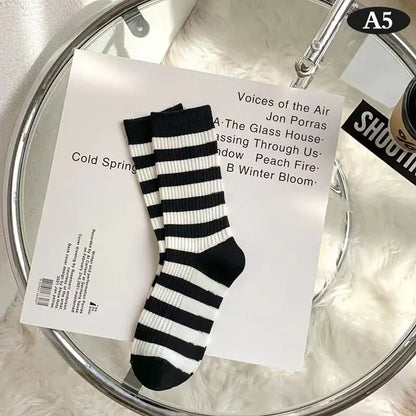 Stylish striped middle tube socks in black and white, enhancing the luxurious appeal of Women's Tie-Dye Middle Tube Socks for vibrant comfort.
