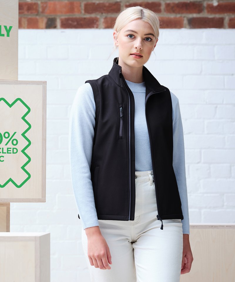 Luxury recycled insulated women's bodywarmer featuring a water-repellent and wind-resistant softshell fabric, designed with multiple zipped pockets for modern elegance.