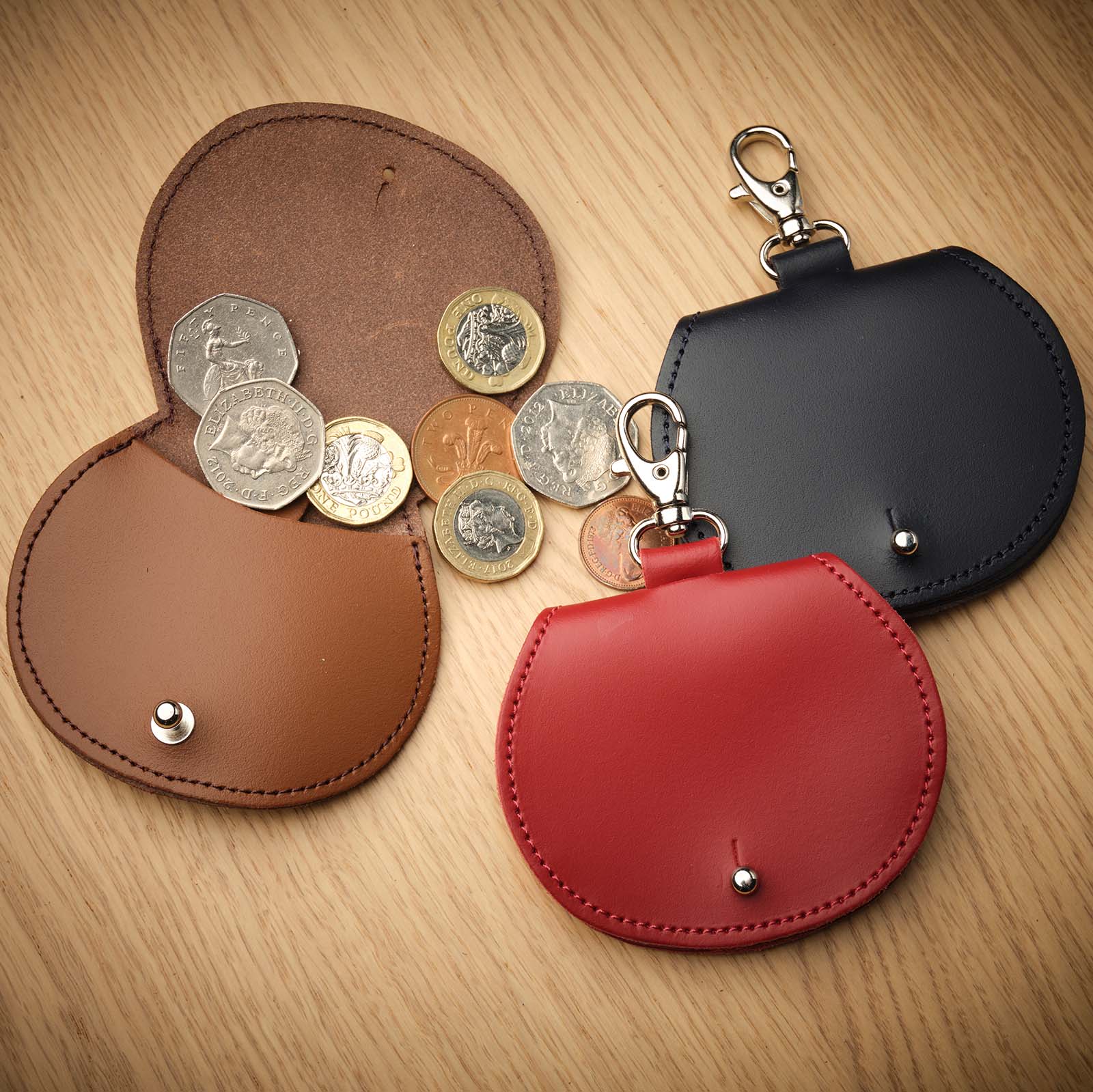 Elegant Luxury Mini Saddle Bag Coin Purse Charm by Zatchels, featuring premium oxblood leather and a stylish clip, perfect for adding sophistication to any handbag.