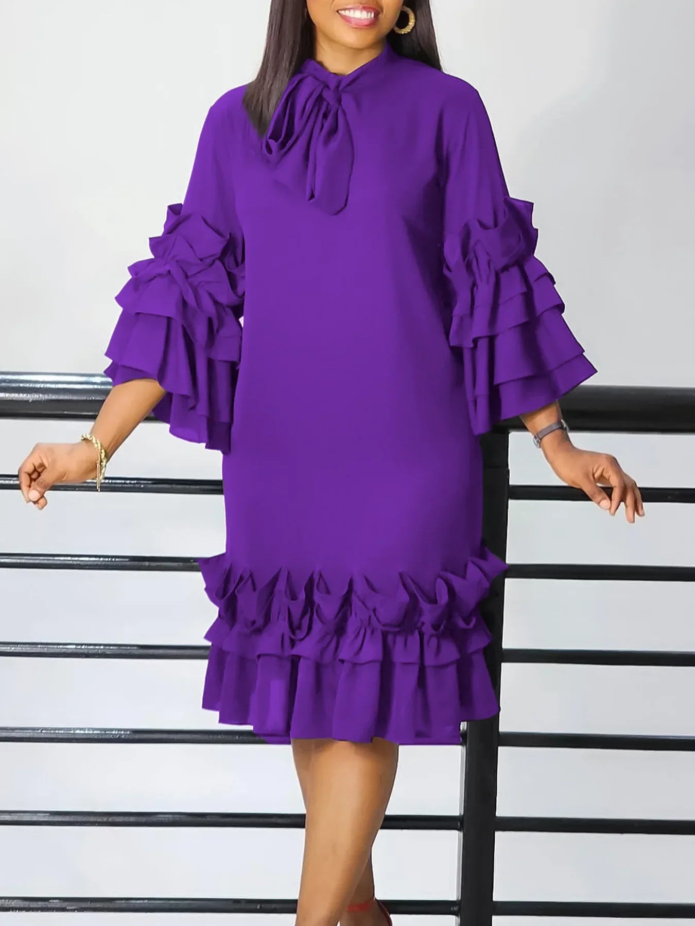 Luxurious mid-calf purple dress with three-quarter flared sleeves and a chic bow neckline, designed for plus size women seeking elegance and comfort.