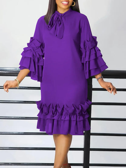 Luxurious mid-calf purple dress with three-quarter flared sleeves and a chic bow neckline, designed for plus size women seeking elegance and comfort.