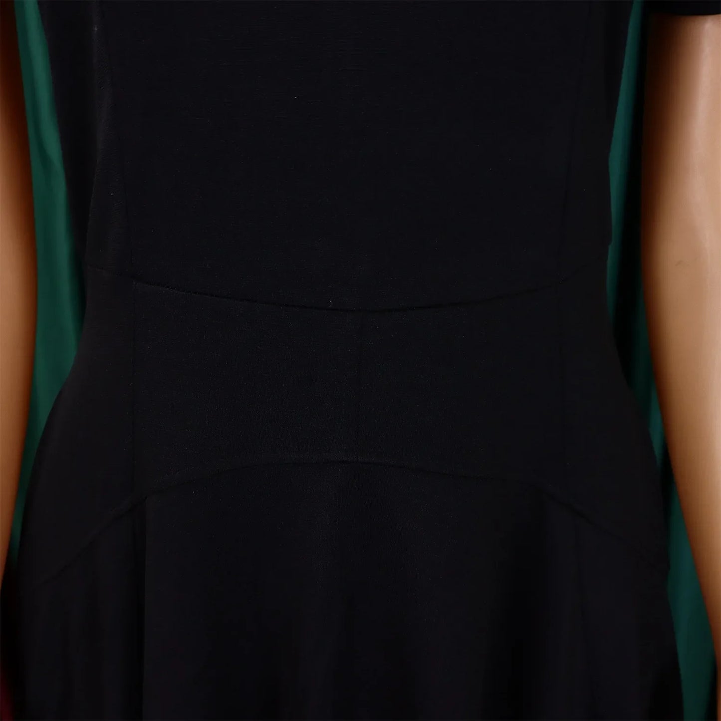 Close-up view of high-quality polyester and spandex fabric of a luxury women's pleated dress, showcasing exquisite workmanship.