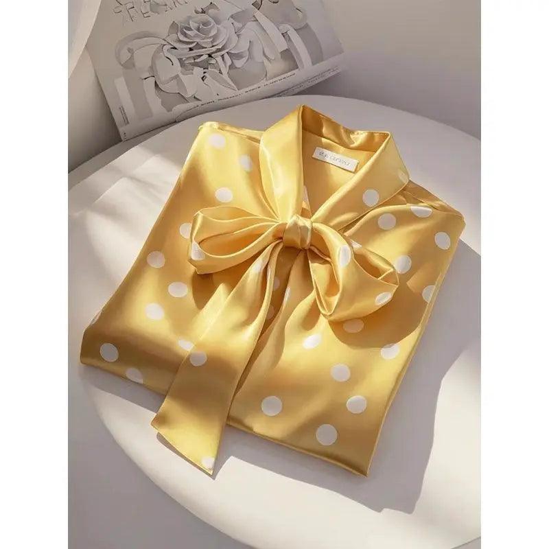 Sophisticated Women’s blouse with a lace-up bow and polka dots, designed for elegance and comfort in the workplace.
