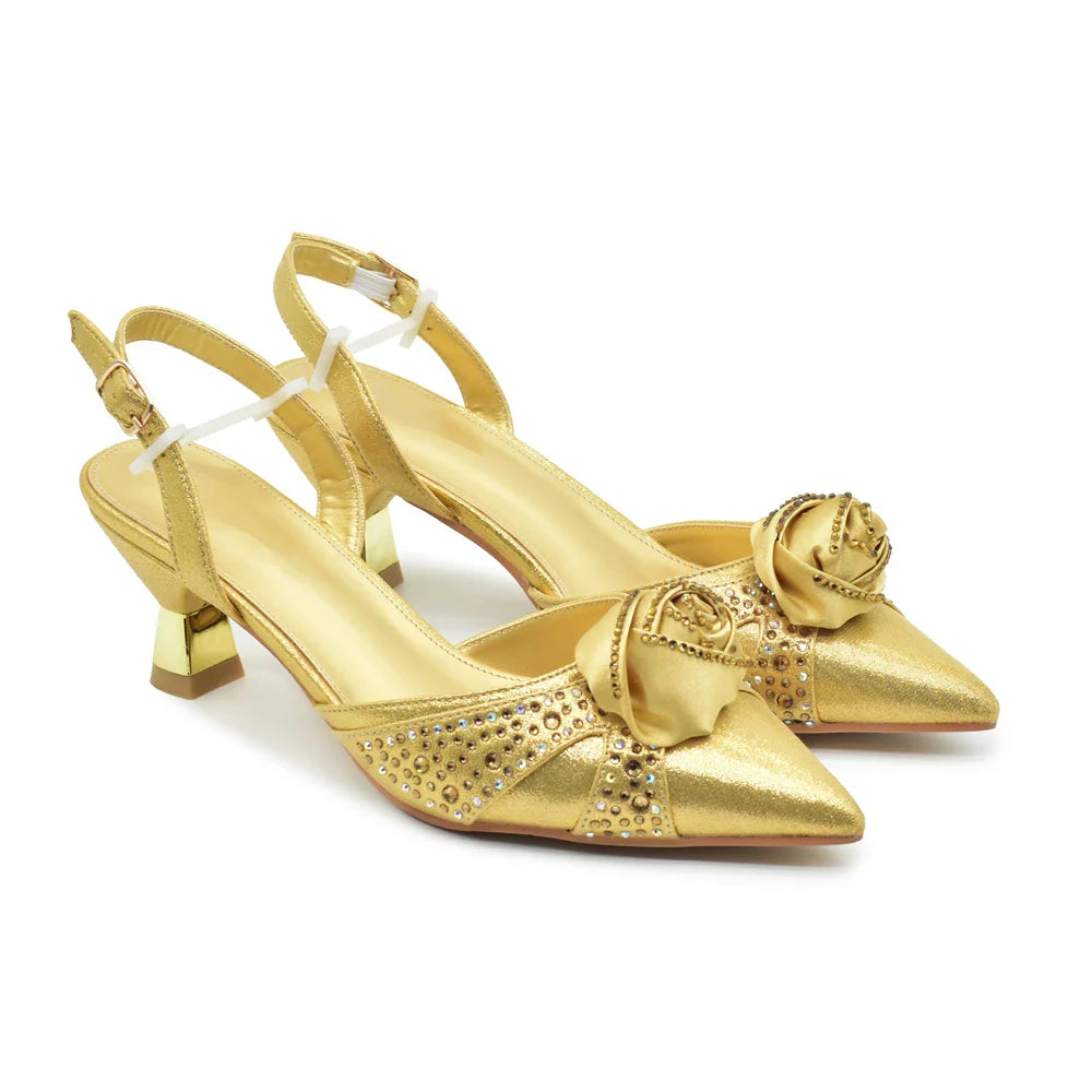 Close-up of luxurious gold and blue pointed toe heels from the Italian shoe and bag set with exquisite crystal embellishments.