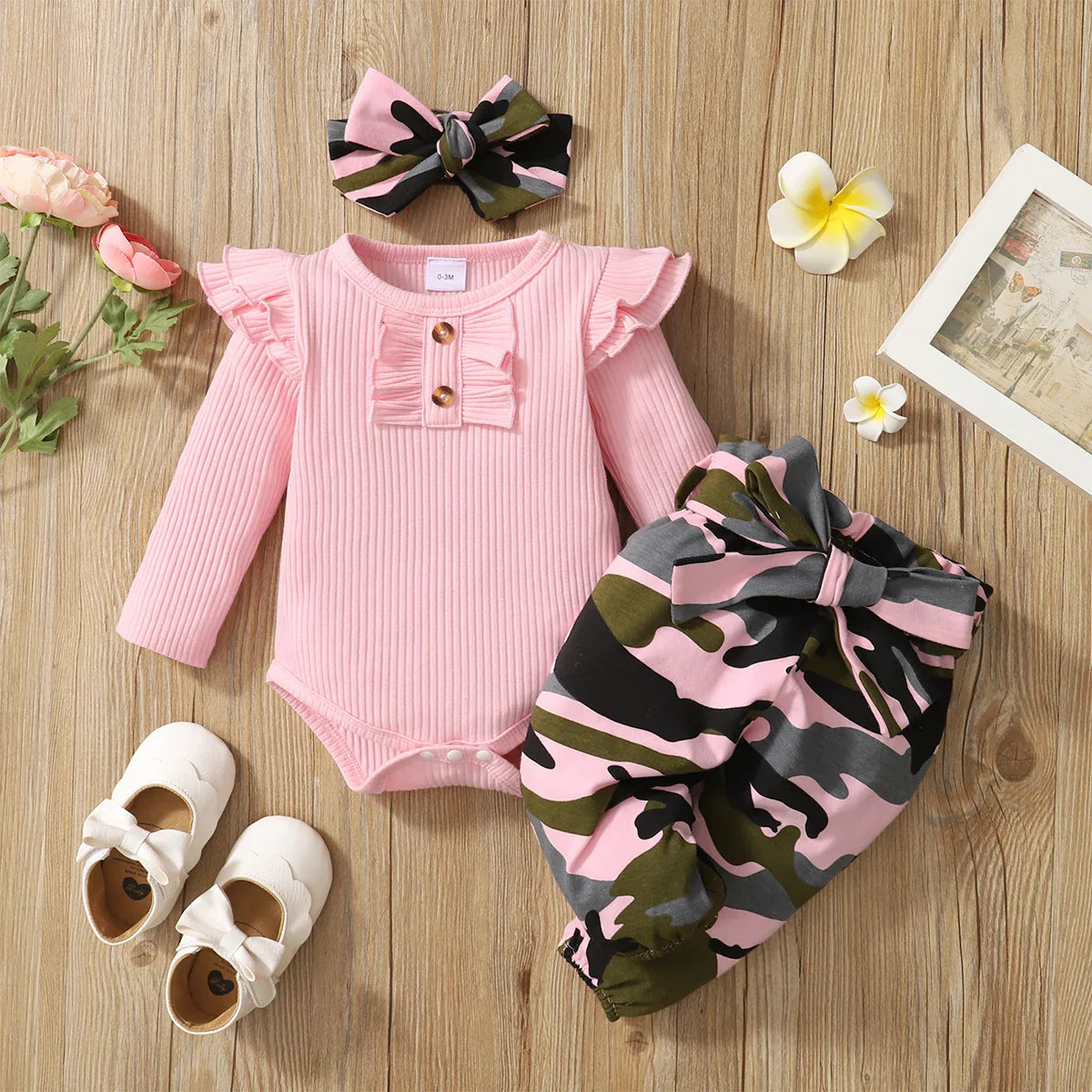 Close-up of luxury knitted baby outfit, showcasing the premium combed cotton fabric in a trendy camouflage design.