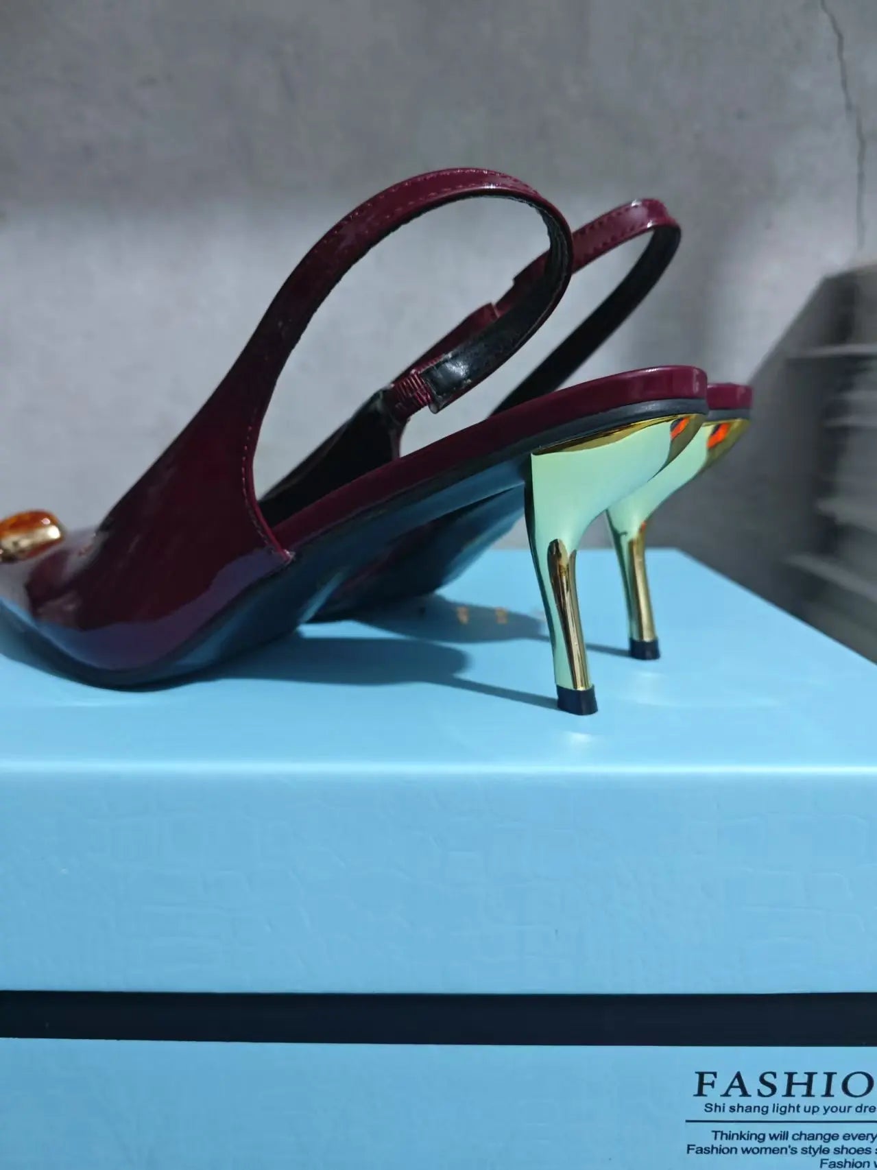 Sophisticated red high heel sandals with a unique fox head jewel, perfect for adding glamour to any outfit.