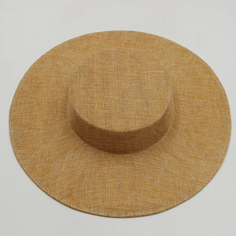 Stylish sinamay fascinator hat displayed on a delicate stand, featuring a flat top and saucer shape, perfect for a sophisticated event ensemble.