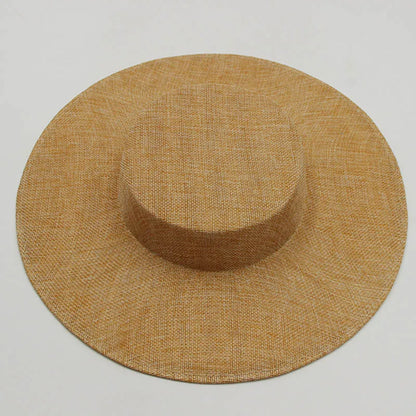 Stylish sinamay fascinator hat displayed on a delicate stand, featuring a flat top and saucer shape, perfect for a sophisticated event ensemble.