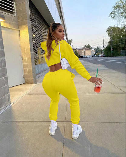 Complete view of the luxury women's pink fleece tracksuit ensemble, featuring both the cropped hoodie and jogger pants, elegantly styled for active women.