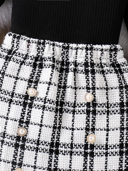 Delightful girls' 2-piece set display, showcasing the luxurious deep colours and sophisticated pattern of the knitted top and plaid skirt for ages 4-6Y.