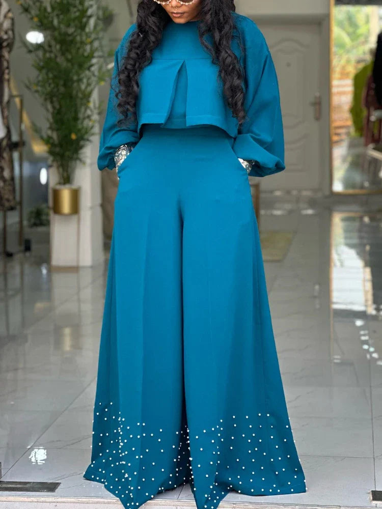 Stylish wide-leg trousers from an elegant women's outfit set, designed for comfort and sophistication, perfect for office wear and evening events.