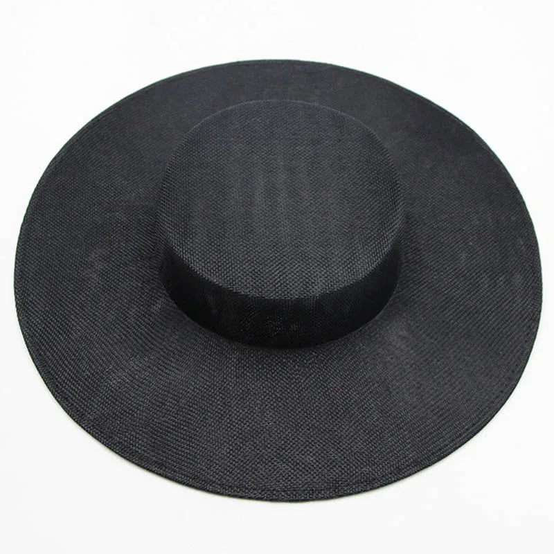 Beautiful sinamay fascinator hat in classic black, effortlessly stylish with its wide brim, perfect for sophisticated celebrations and formal events.