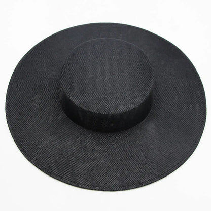 Beautiful sinamay fascinator hat in classic black, effortlessly stylish with its wide brim, perfect for sophisticated celebrations and formal events.