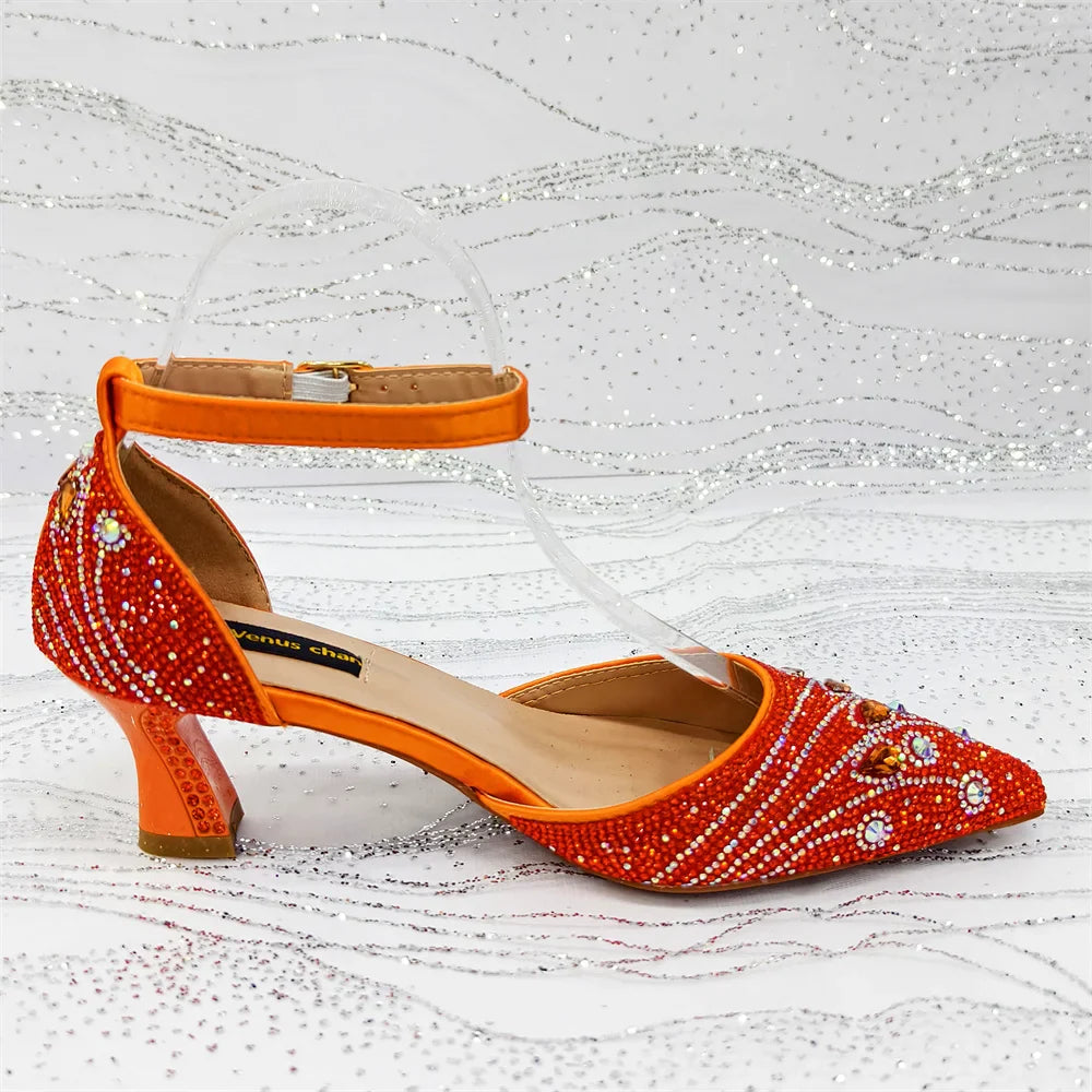 Close-up of high spike heel on women's rhinestone pumps, highlighting the intricate bling and fashionable summer design.